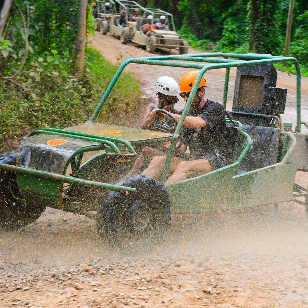 Convoy of off-road buggies driving through the jungle