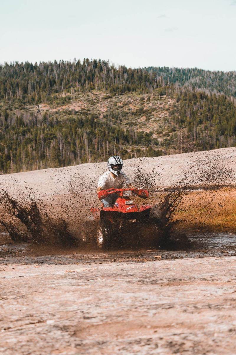 ATV quad rider splashing through mud in Punta Cana